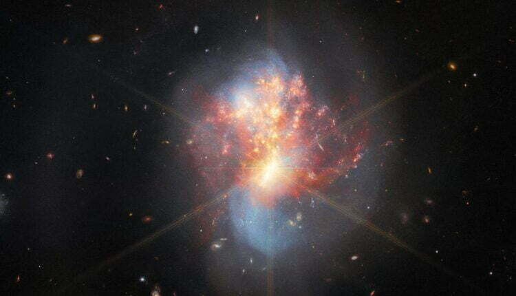 photo of collision of two galaxies and birth to new stars